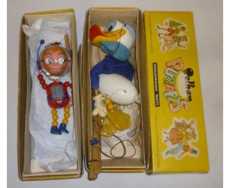 Two Pelham puppets; Space Boy with plastic helmet, 7 1/2" high, in yellow box (AF), Donald Duck in yellow box and empty yello