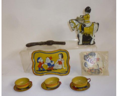 A mounted Guardsman Drummer, tinplate, novelty clockwork action, British made, 5 1/2" high, a "Happynak" tinplate Snow White 