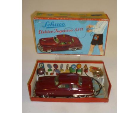 A Schuco Ingenico 5311 remote control car, tinplate, battery powered, complete with road signs and tools, but no battery hold
