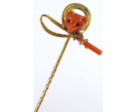 A Victorian hunting design tiepin, designed as a coral fox mask in horseshoe surround and coral-ended hunting whip, unmarked 