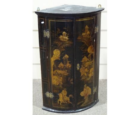 An 18th century chinoiserie gilded and lacquered bow-front hanging corner cupboard