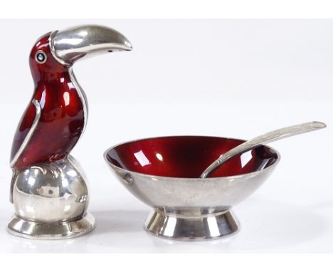 A Danish sterling silver and red enamel cruet set, comprising toucan-shaped pepperette and salt bowl with spoon, by Volmer Ba