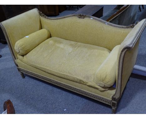 A French carved and gilded parlour sofa, with scrolled arms and floral carved decoration 