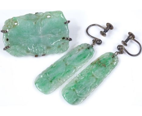 A carved jade brooch, length 32.5mm, together with a pair of carved jade earrings (2) 