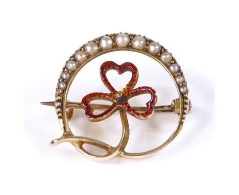 An Edwardian 15ct gold pearl and red enamel brooch, with graduated pearl set crescent and enamelled 3-leaf clover, 20mm acros