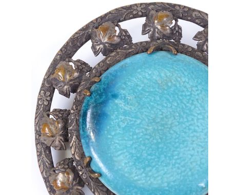 An Arts and Crafts ceramic Ruskin panel brooch, unmarked white metal settings, brooch diameter 76.7mm 