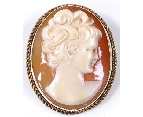 A relief carved cameo panel brooch, in 9ct gold frame with rope twist surround, depicting female portrait, brooch height 38.3