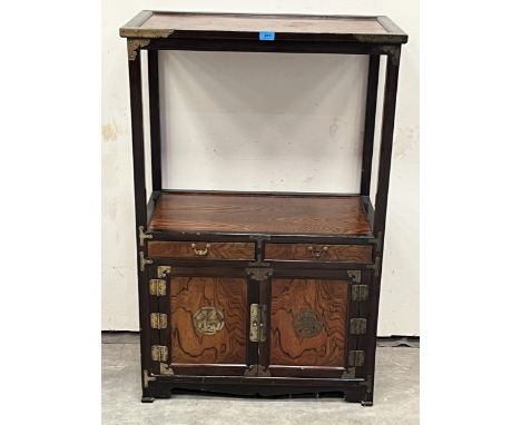 An Asian Chosun cabinet with open shelf over a pair of drawers and fretted brass applied doors. 30"w x 45½".
