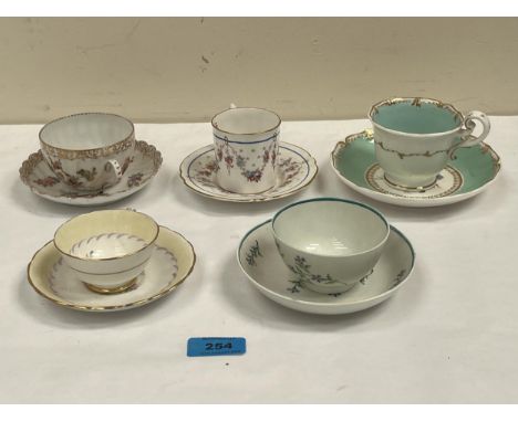 Four English porcelain cups and saucers and a Dresden example. 18th-20th Centuries.