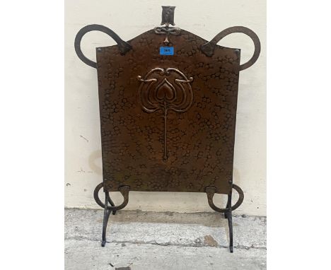 An Art-Nouveau copper fire screen, embossed with a stylised tulip. 30" high.