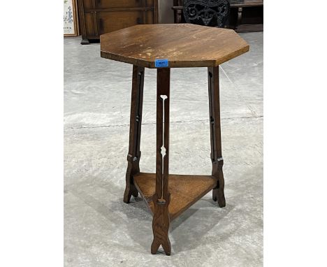 An Arts and Crafts oak octagonal two-tier lamp table.