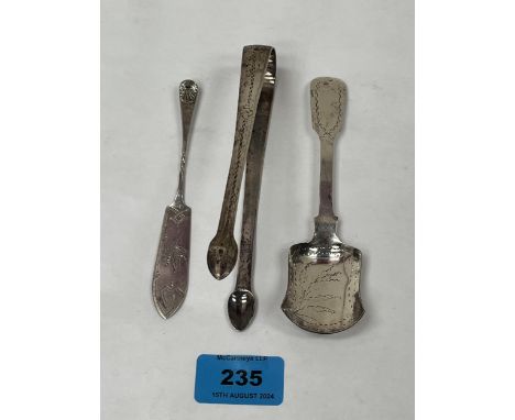 A Georgian silver bright cut sugar bow; a Georgian silver bright cut caddy or sugar spoon and a silver bright cut butter knif