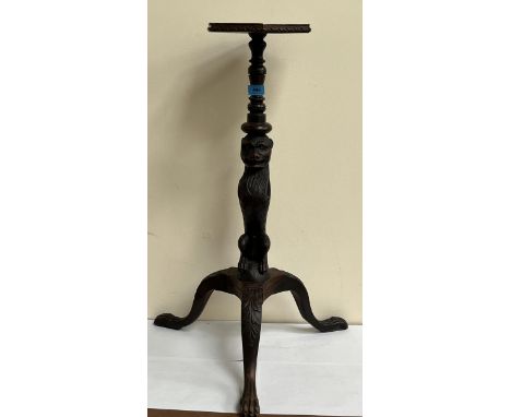 A 19th Century walnut lamp table, the column carved as a lion, on acanthus carved tripod support. 29½" high.