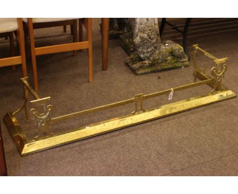 Art Nouveau style brass fender.