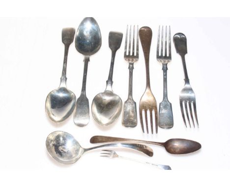 Silver flatware including fiddle pattern dessert spoons and forks and sauce ladle.