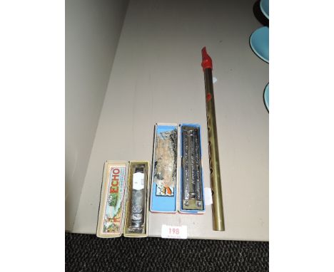 Two vintage harmonicas in boxes and a tin whistle.