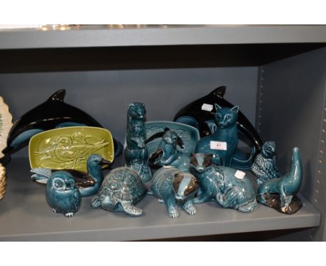 A selection of dolphin blue glaze ceramic figures by Poole pottery
