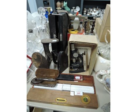 A miscellany of items amongst which are a vintage micrometer and level, cobblers last,microscope and Eumig chemo splicer.