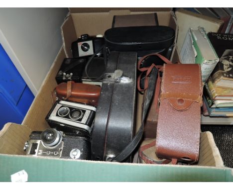 A box full of vintage cameras and similar including Kodak Duaflex II, Brownie junior,Brownie 127 and more.