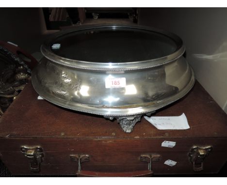 A vintage wedding cake stand having mirrored face and etched design to front.