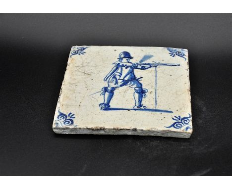 Dutch Delftware blue on white tin glazed tile c. 1690, depicts a musketeer discharging his weapon There is some crazing and a