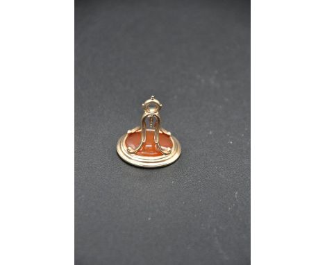 English 14ct gold-mounted intaglio fob seal, unmarked, ovate bezel supported by ornate 4-armed suspension arch and suspension