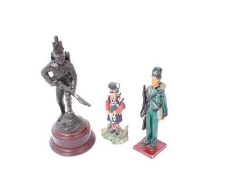 Bronzed figure of a Rifle Brigade Soldier, together with other military figures and a German pipe.