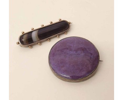 Ruskin ceramic brooch in sterling silver mount and an Edwardian yellow and white metal brooch supporting a section of banded 