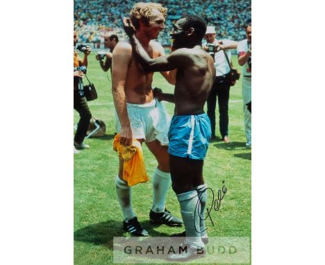 Pele signed colour photographic print swapping jerseys with Bobby Moore at the 1970 World Cup, signed in black marker pen Pel