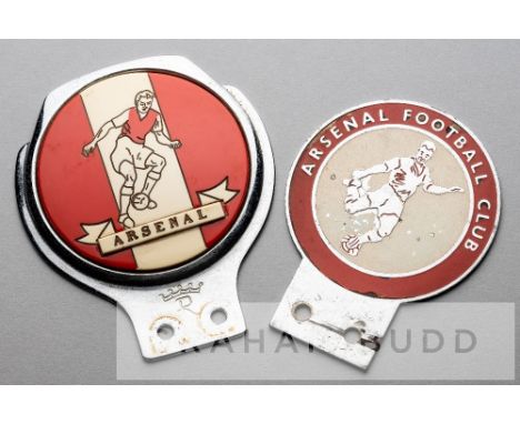 Two Arsenal FC red and white car grille badges, circa 1960s,the first featuring a footballer with ball and lettered ARSENAL o