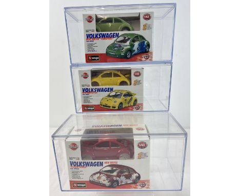 3 boxed Burago 1/43 scale Volkswagen Beetle diecast metal kits. 'New Beetle Cup' in yellow #49501, 'Funsport' in green #49422