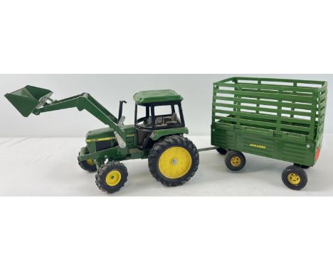 An Ertl 1/16 scale John Deere tractor and trailer. #2755 tractor with 3 position front loader together with a high sided trai