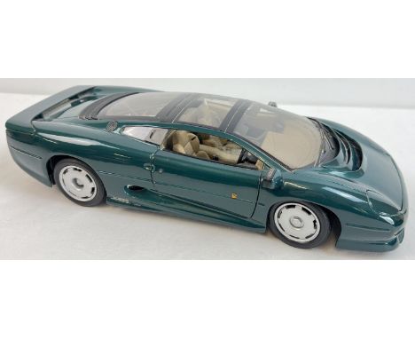 A Maisto Jaguar XJ220 scale 1/12 diecast model car in green. With opening doors and bonnet. 