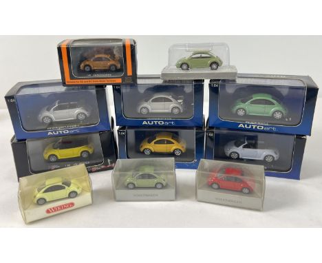 11 assorted boxed VW new shape Beetle diecast model cars, in varying sizes and colours. To include 5 x Auto Art 1/64 scale ca