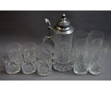 Two sets of six cut glasses and a cut glass pitcher. Pitcher approximately 25 cm tall. 