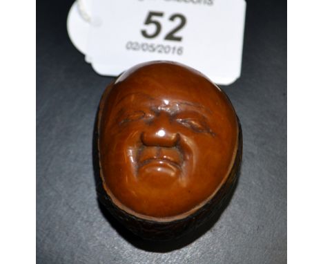 A carved coquilla - nut Netsuke, signature appears to be Masakazu 