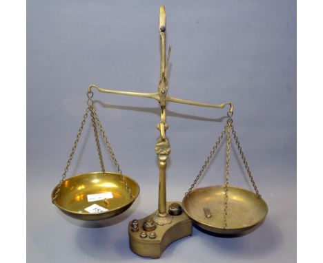 A set of brass weighing scales with a set of weights. Approximately 35 cm tall. 