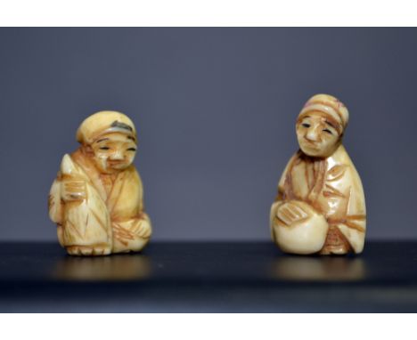 A pair of miniature carved bone oriental Netsuke, each with a signature to the base