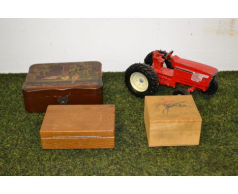 A vintage toy tractor and three boxes