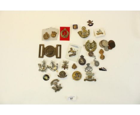 Selection of British military cap badges, emblems, belt buckles,  mainly WWI through WWII, highlights 14th Kings Hussars cap 