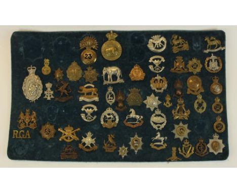 Framed and mounted display of approx fifty one British military cap badges including Royal Hampshire, King's Dragoon Guards, 