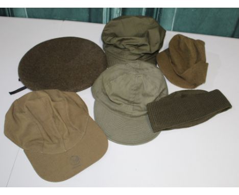 Two General purpose caps, a wooly jeep cap, a Flying cap with leather sweat band, British Beret, WW2 A-4 mechanics skull cap 