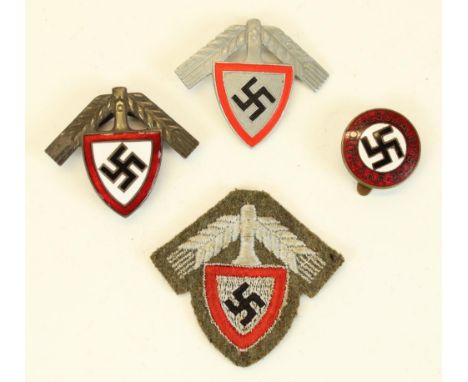 Three German Third Reich Labour Service badges and a NSDAP enamel badge 