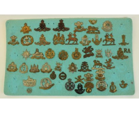 Framed and mounted display of approx forty nine British military cap badges including Army Cyclist Corp, Royal Artillery, Kin