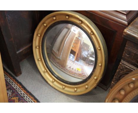 A convex gilt ball decorated wall mirror, plate 13 1/2" dia