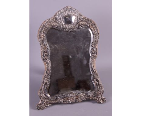 An Edwardian silver faced strut mirror with repousse decoration, 12" high