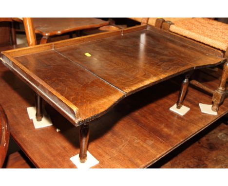 An adjustable bed table and a mahogany three-tier open wall shelf, 24" wide