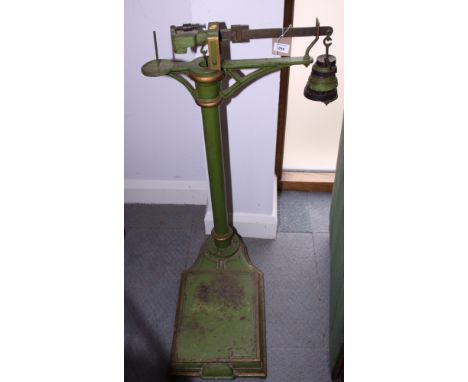 A set of green and gilt painted personal weighing scales