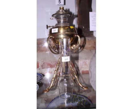 A late 19th century brass oil lamp (now converted to electricity) with two shades and a chimney