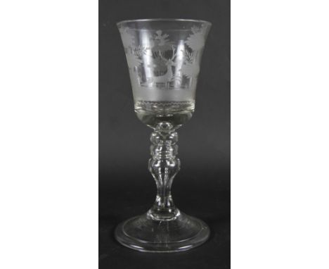 A 19th century glass goblet, bell-shaped bowl wheel engraved stag hunting scene, knopped stem with tear, on folded foot, 9" h